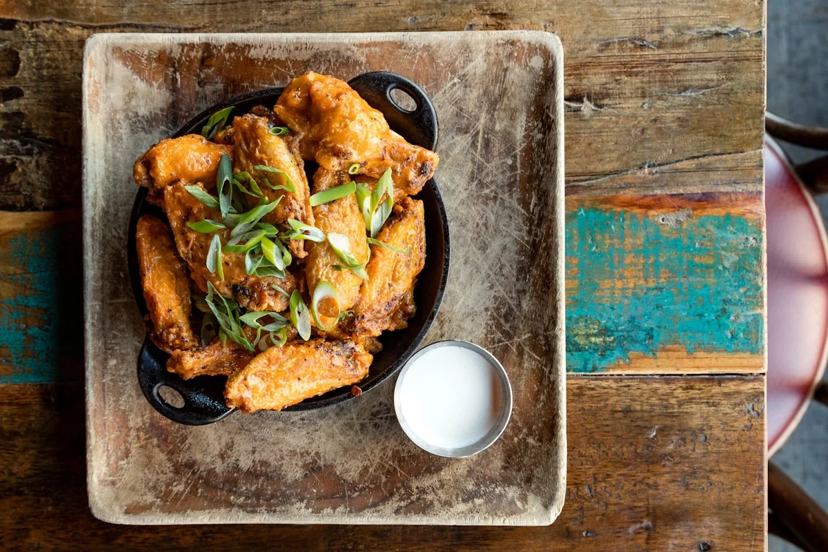 Chicken wings served in a cast-iron skillet