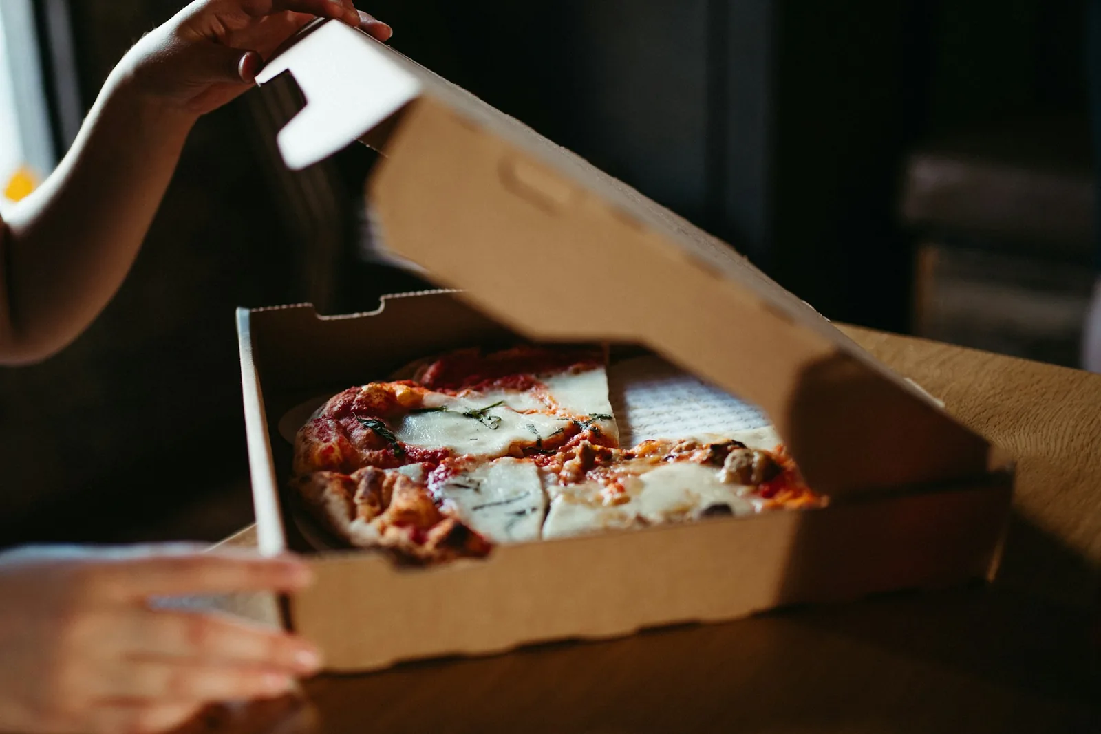 Leftover pizza slices in an open box
