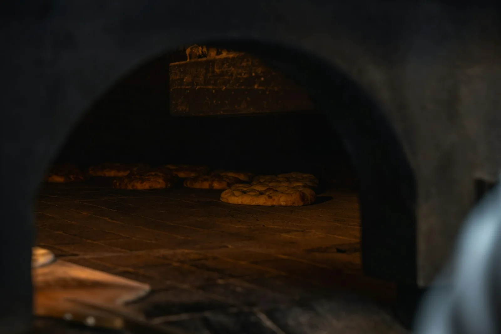 The dark interior of a wood-fired oven