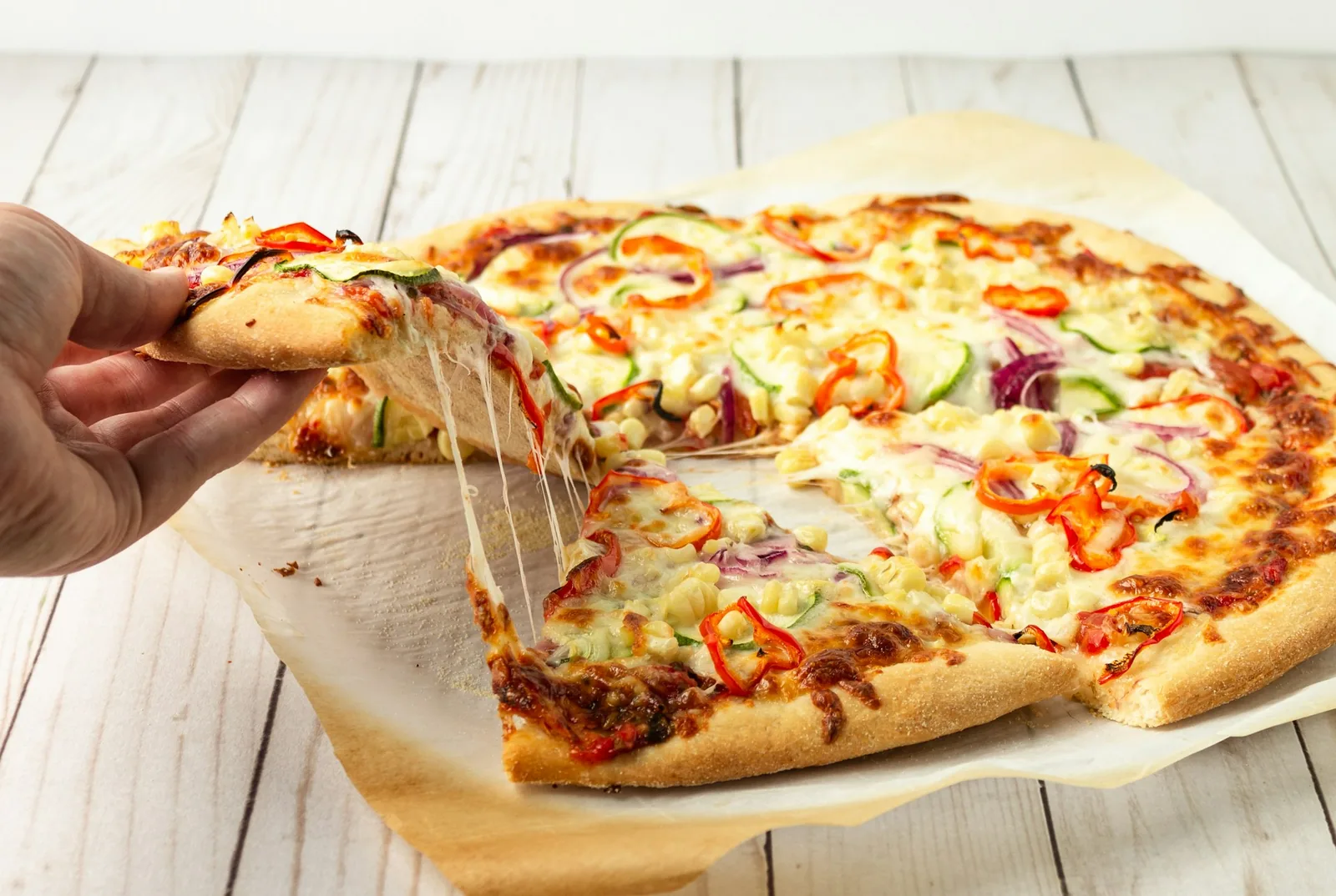 A thin-crust pizza slice