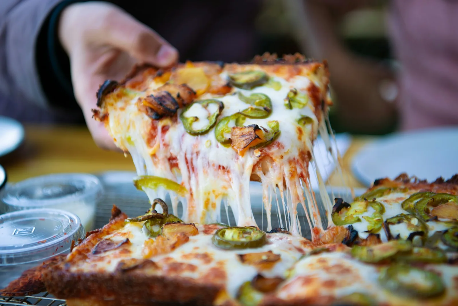 A pizza slice held in one hand