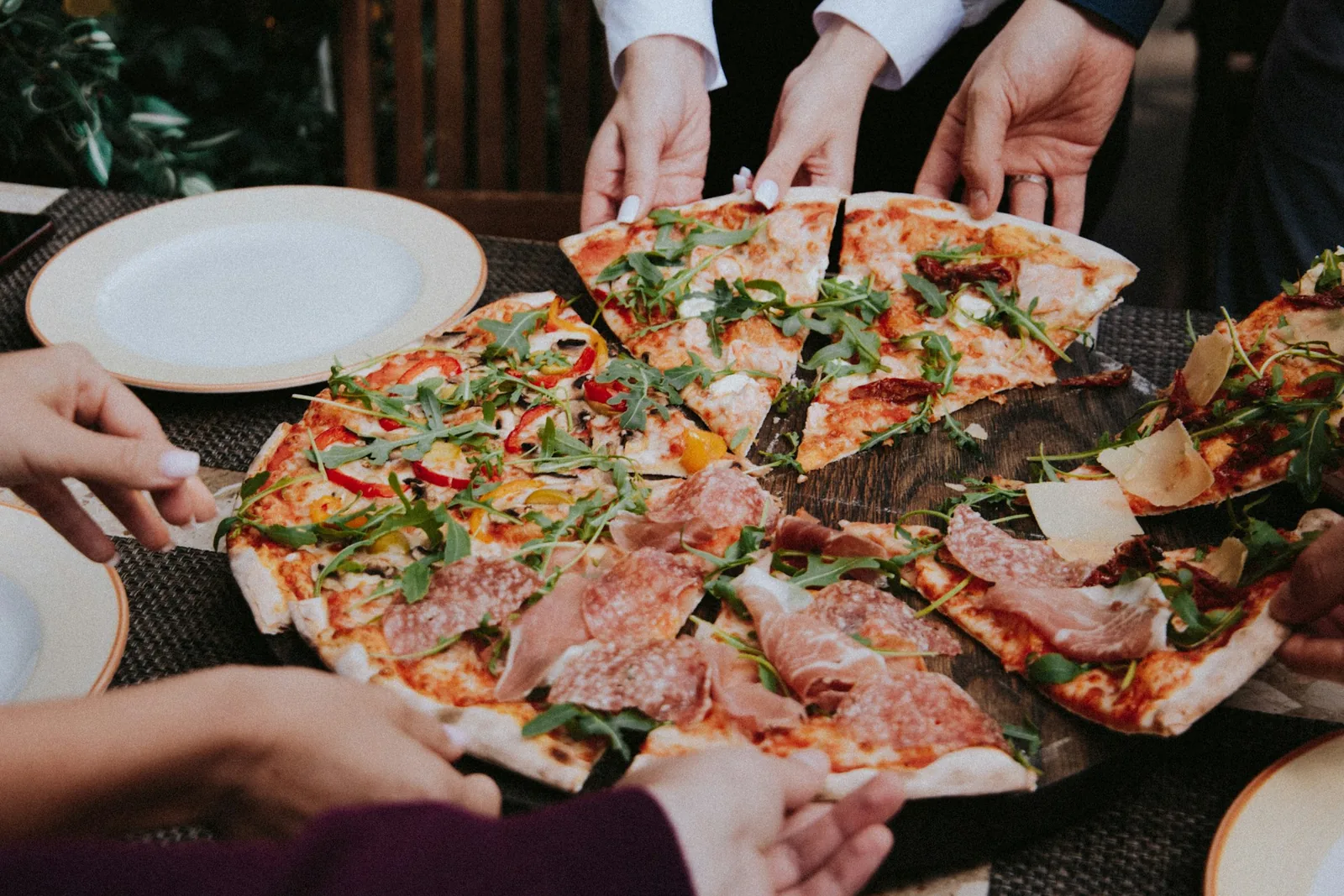 A hand taking a slice