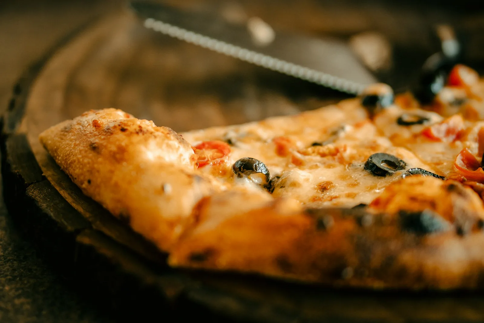 A pizza slice on a dark background